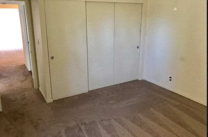 a room with a carpeted floor and white walls