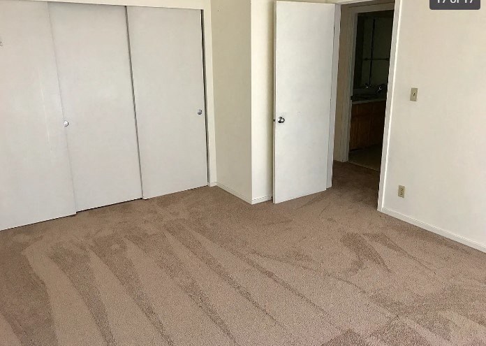 an empty room with a carpeted floor
