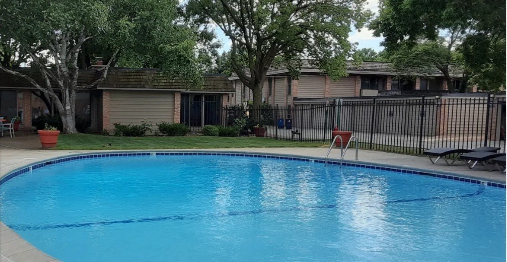 a large swimming pool in front of a house