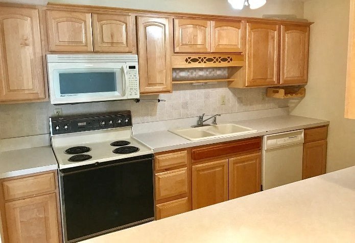 a kitchen with a stove a sink and a microwave