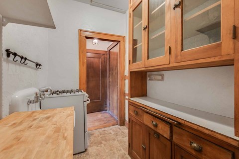 a kitchen with wooden cabinets and a stove and a sink