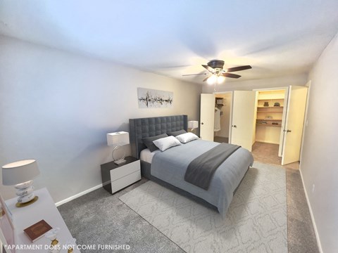 a bedroom with a bed and a ceiling fan