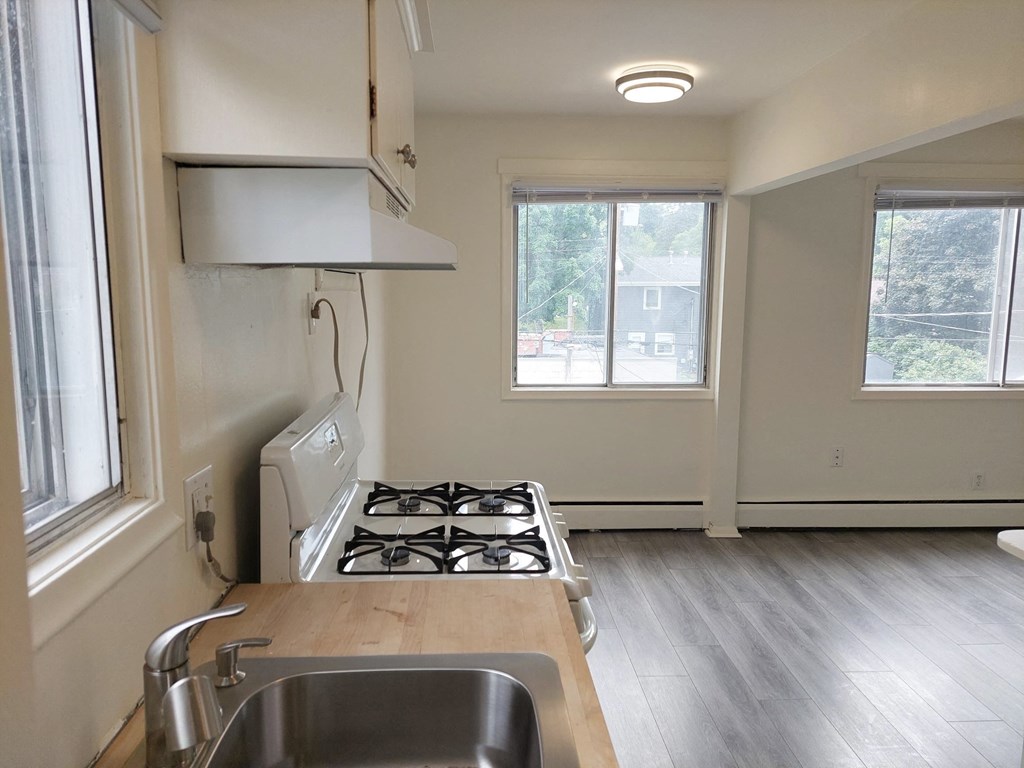 an empty kitchen with a stove and a sink
