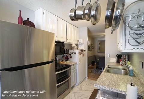 a kitchen with stainless steel appliances and white cabinets