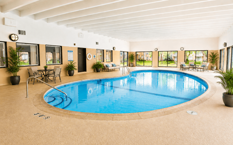 A large indoor swimming pool with a sunken seating area.