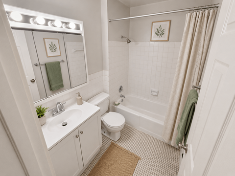 A white bathroom with a toilet, sink, and shower.