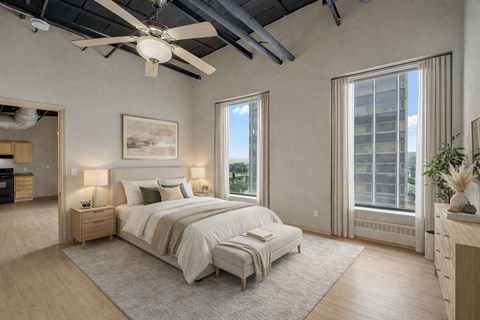 A bedroom with a large bed and a ceiling fan.