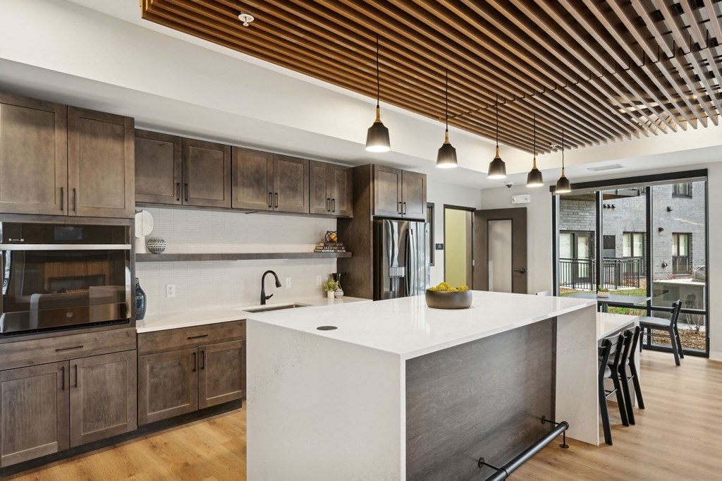 Wangstad Commons, Brooklyn Center,  A modern kitchen with wooden cabinets and a white island.