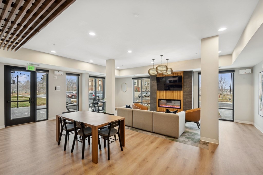Wangstad Commons, Brooklyn Center, A modern dining room with a wooden table and chairs.