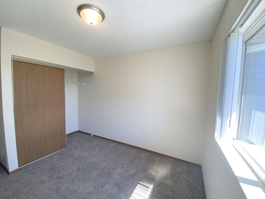 East Gate Estates Living room, New Prague, Minnesota living room with a door to a closet and a window