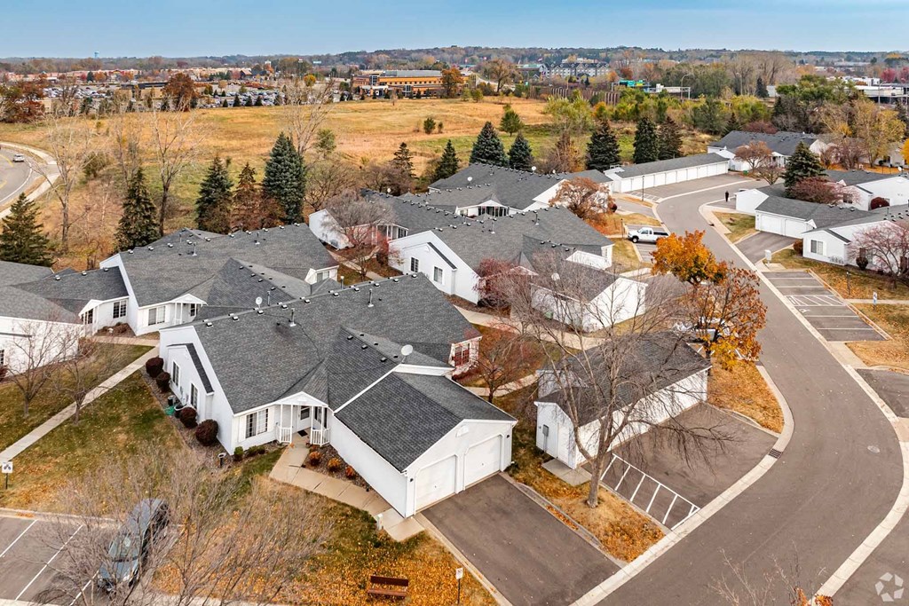 A bird's eye view of a residential area with houses and trees.