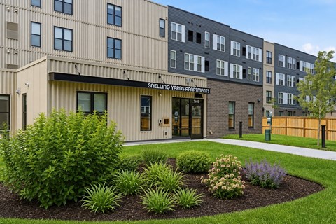 A building with the sign "Shellin Yards Apartments" in front of it.