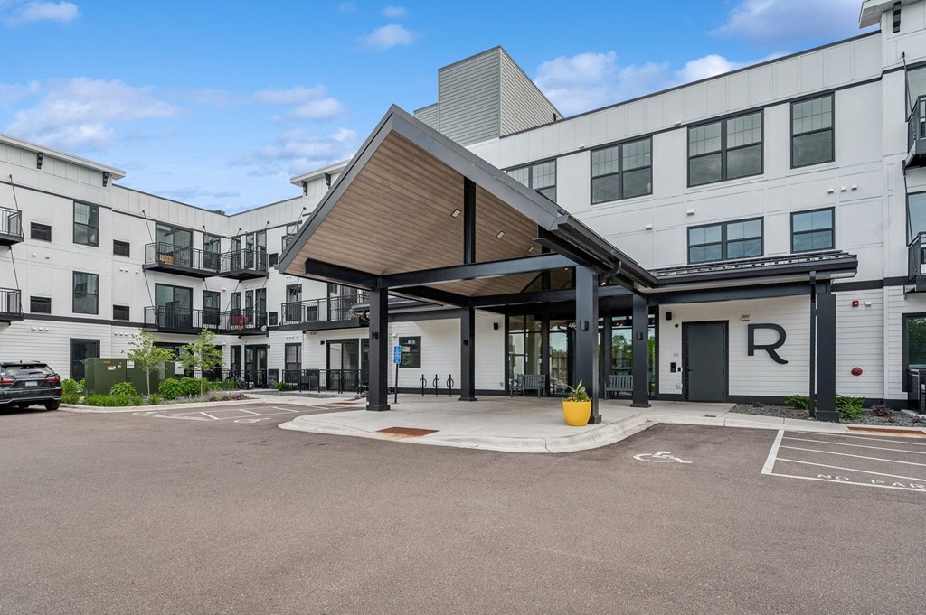 the entrance to a building with a parking lot