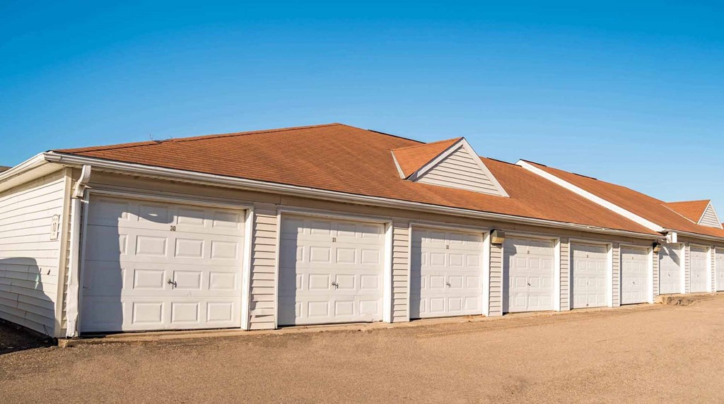 A row of white garage doors are closed.