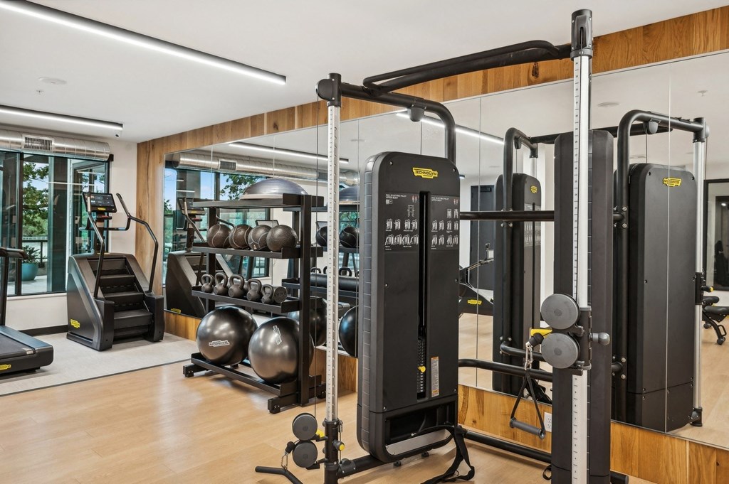 a gym with weights machines and other gym equipment in a home