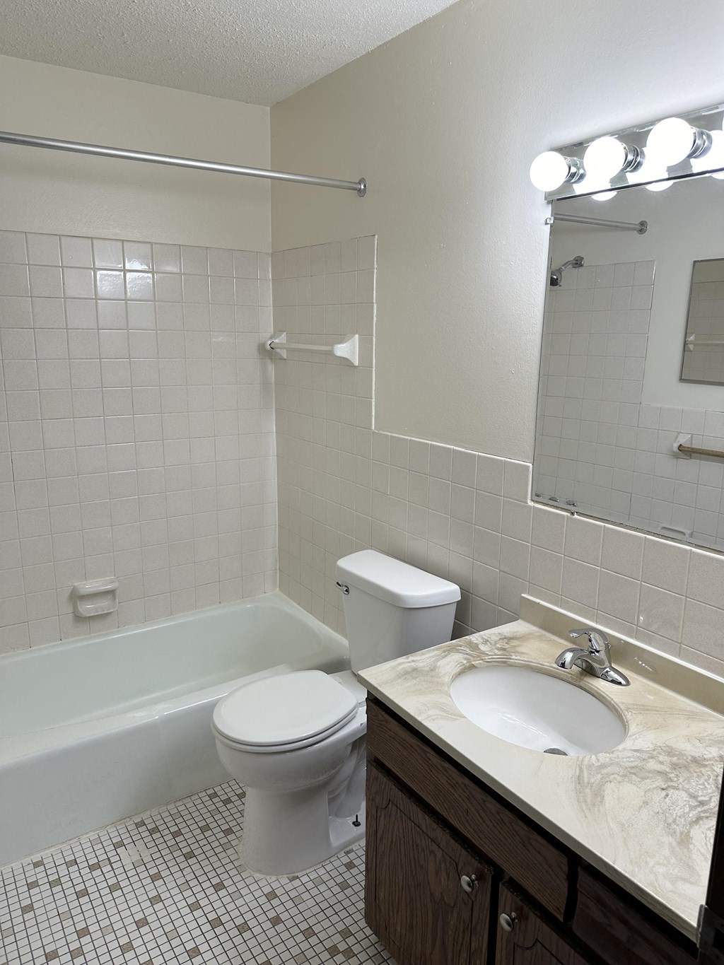 a bathroom with a toilet and a sink and a bath tub