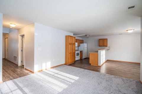 A kitchen area with wooden cabinets and a refrigerator.