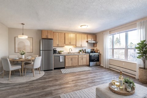 A modern kitchen with wooden cabinets and a dining table set for two.