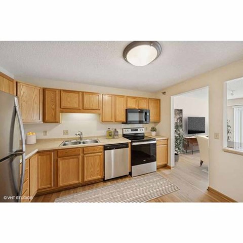 A kitchen with wooden cabinets and stainless steel appliances.