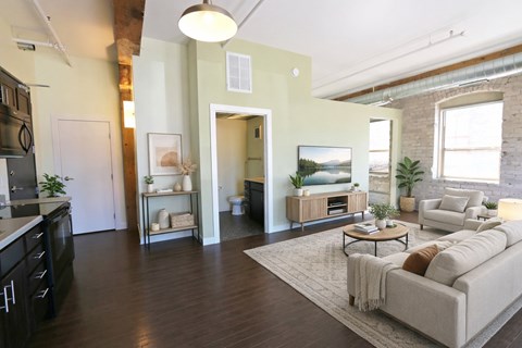 A modern living room with a grey sofa and a coffee table.