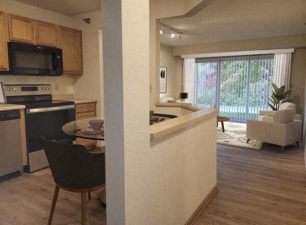 a kitchen and living room with a table and chairs