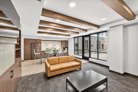 A modern living room with a yellow sofa and a black coffee table.