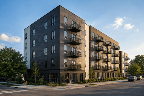 A modern apartment building with balconies on the upper floors.