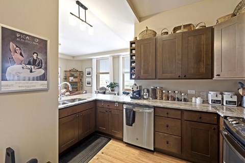a kitchen with wooden cabinets and a poster on the wall