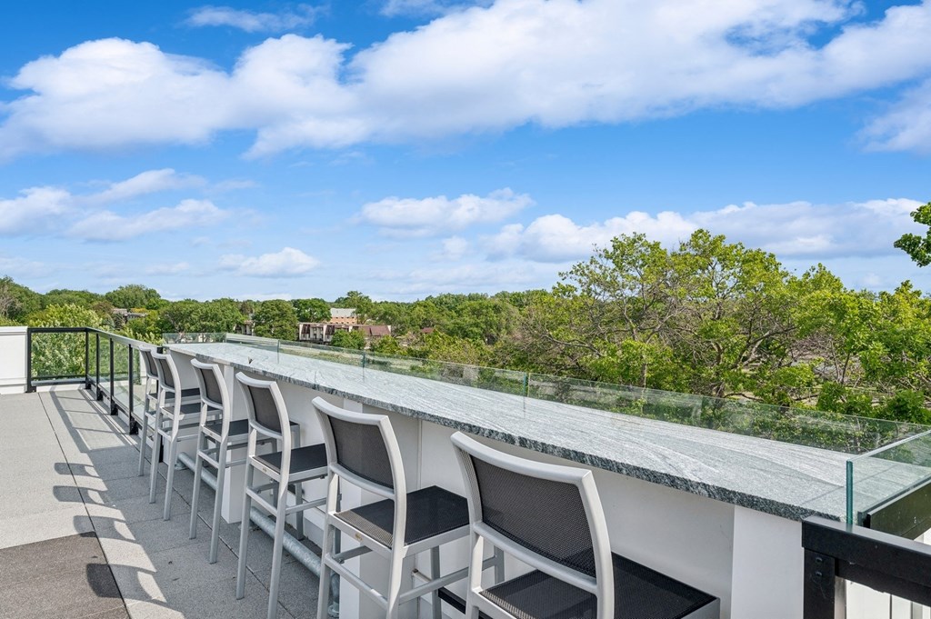 a view of the roof of a building with trees and a blue sky