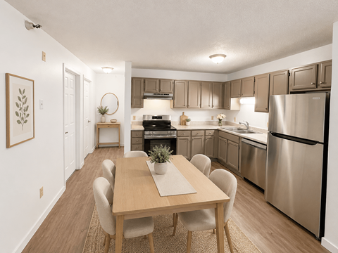 A modern kitchen with a wooden dining table and chairs.