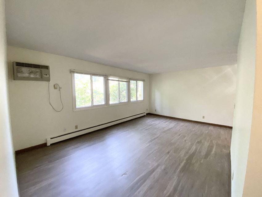 Twin Lakes Living Room an empty room with white walls and a large window