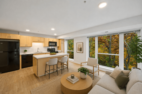 A modern kitchen with a dining area and a couch.