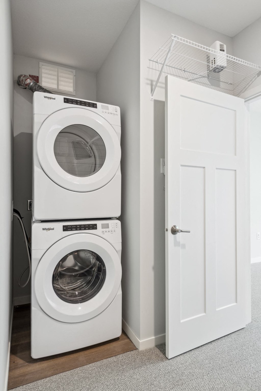 a white washer and dryer in a small laundry room