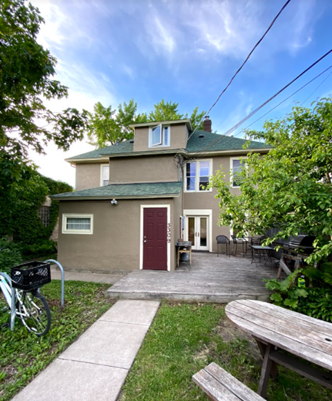 the front of a house with a yard and a sidewalk