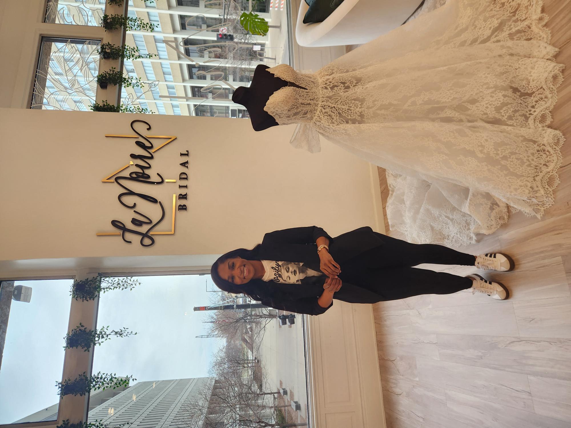 a bride and groom posing for a picture in front of a window