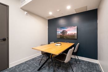 a conference room with a wooden table and chairs