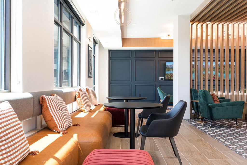 a living room with a couch and chairs and a table