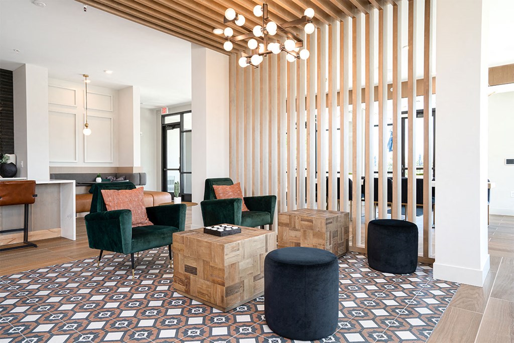 a lobby with chairs and tables and a reception area with a reception desk