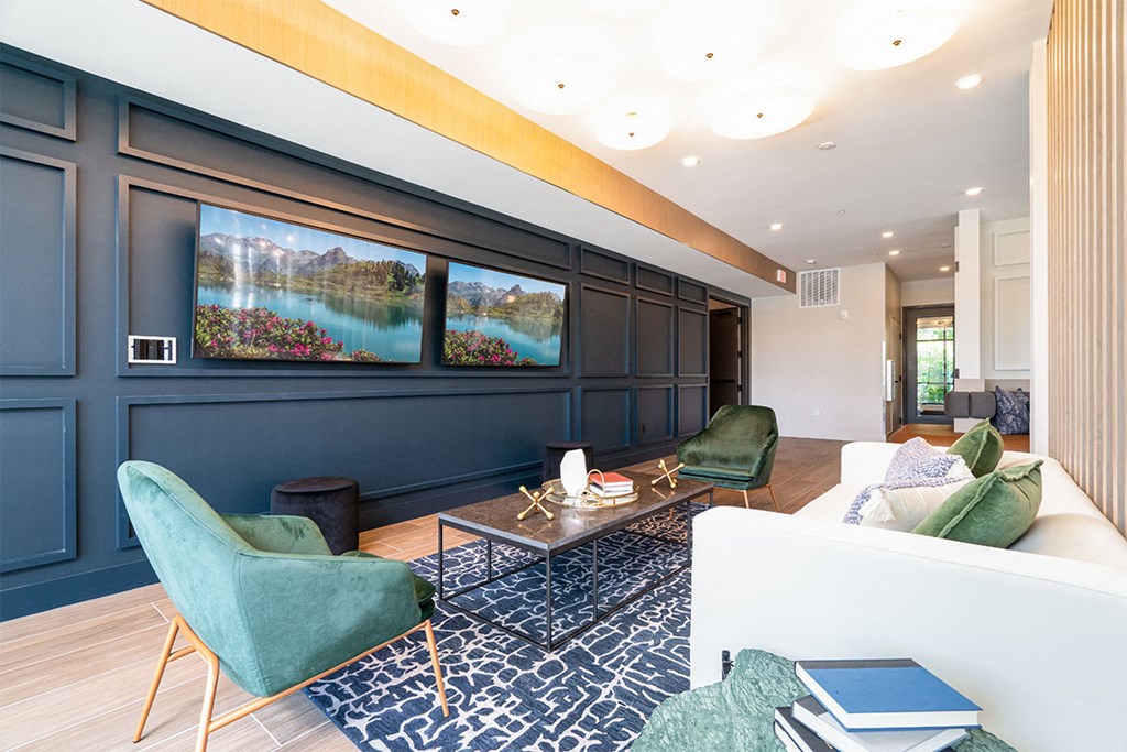a living room with blue walls and a couch and chairs