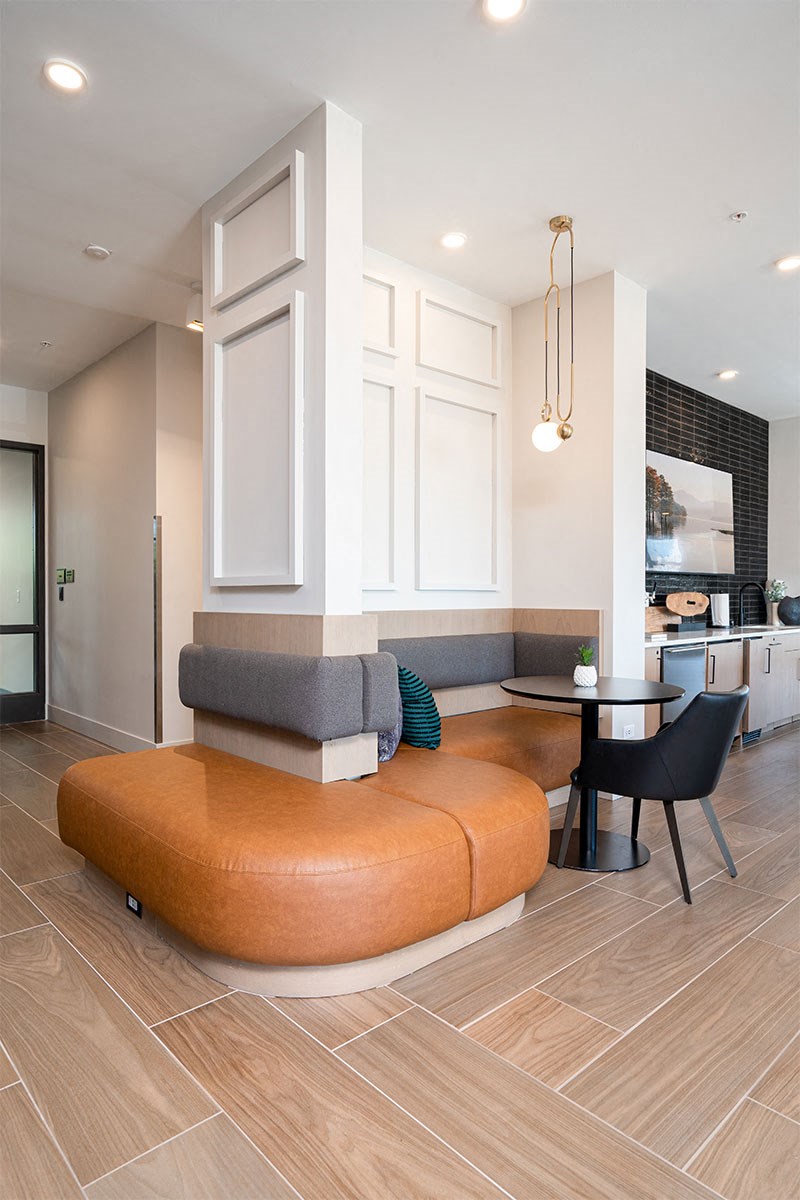 a living room with an orange couch and a table
