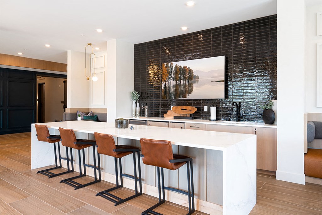 a kitchen with a marble counter top and bar stools