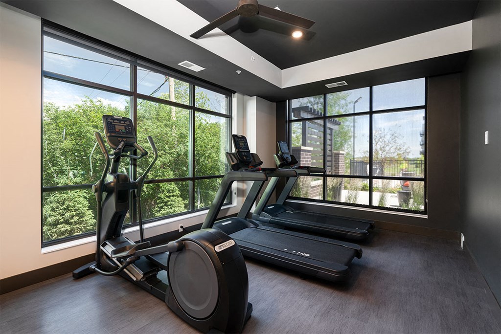the residence has a gym with a window view of the city