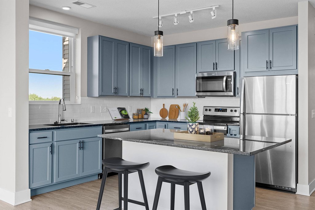 a kitchen with blue cabinets and a counter top