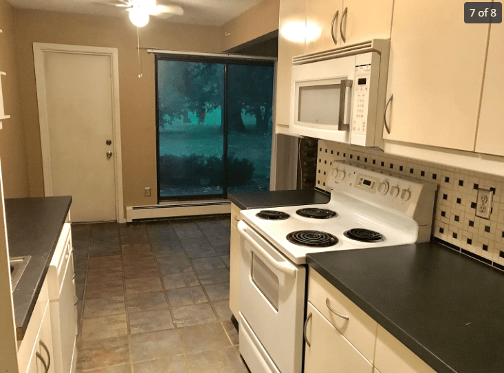 a kitchen with white appliances and white cabinets