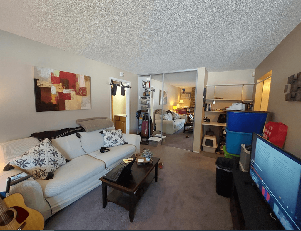 a living room filled with furniture and a flat screen tv