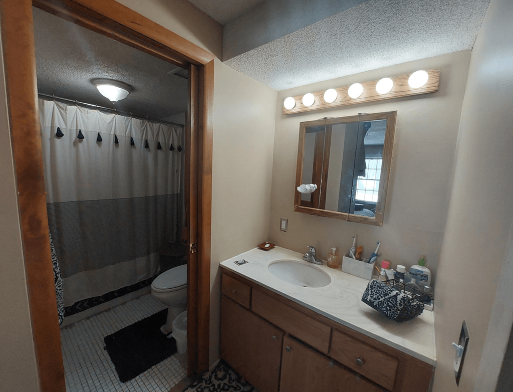 a bathroom with a shower and a sink