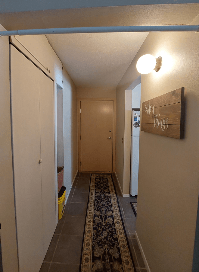 a long hallway with a rug on the floor