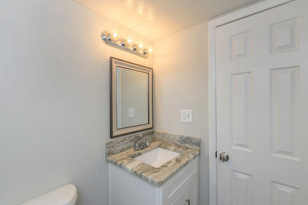 a small bathroom with a sink and a mirror