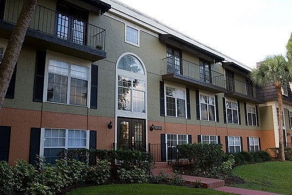 A building with a balcony and a door.