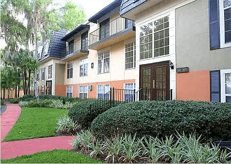 A building with a red walkway in front of it.